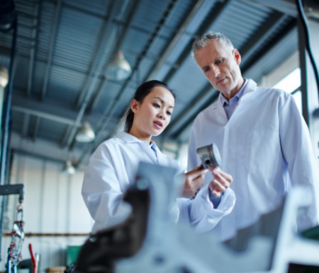 Two engineers study a part