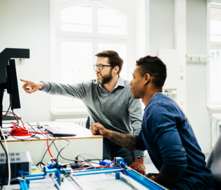 Two engineers look at a computer